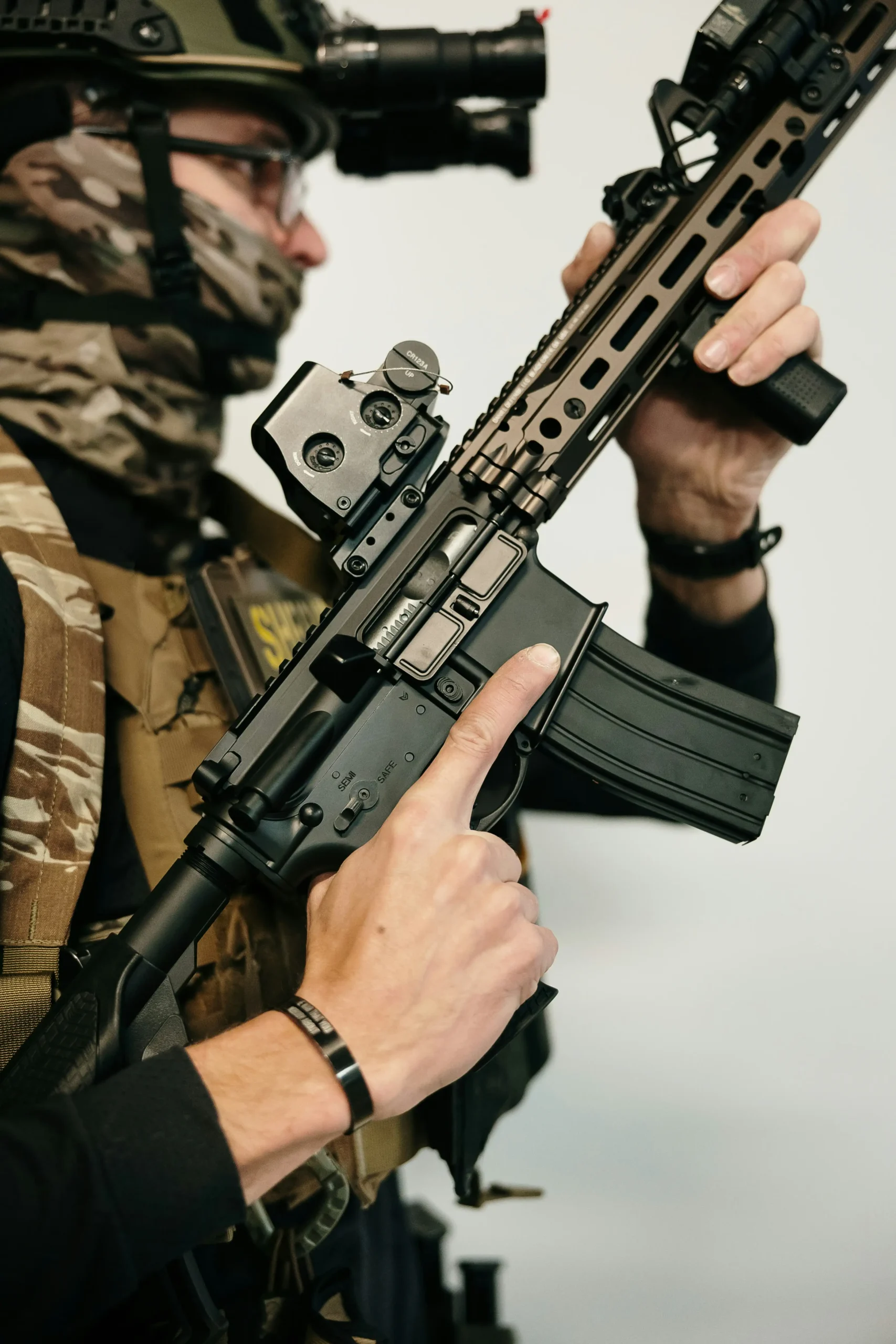 Soldier holding a rifle with a red dot sight