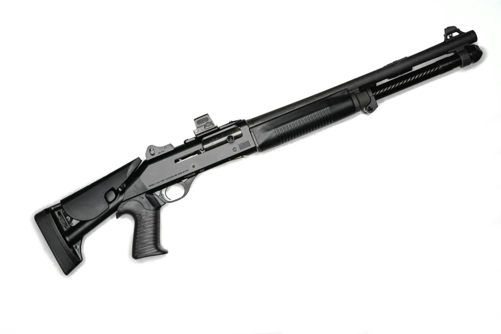 Shotgun with red dot sight mounted in a white background